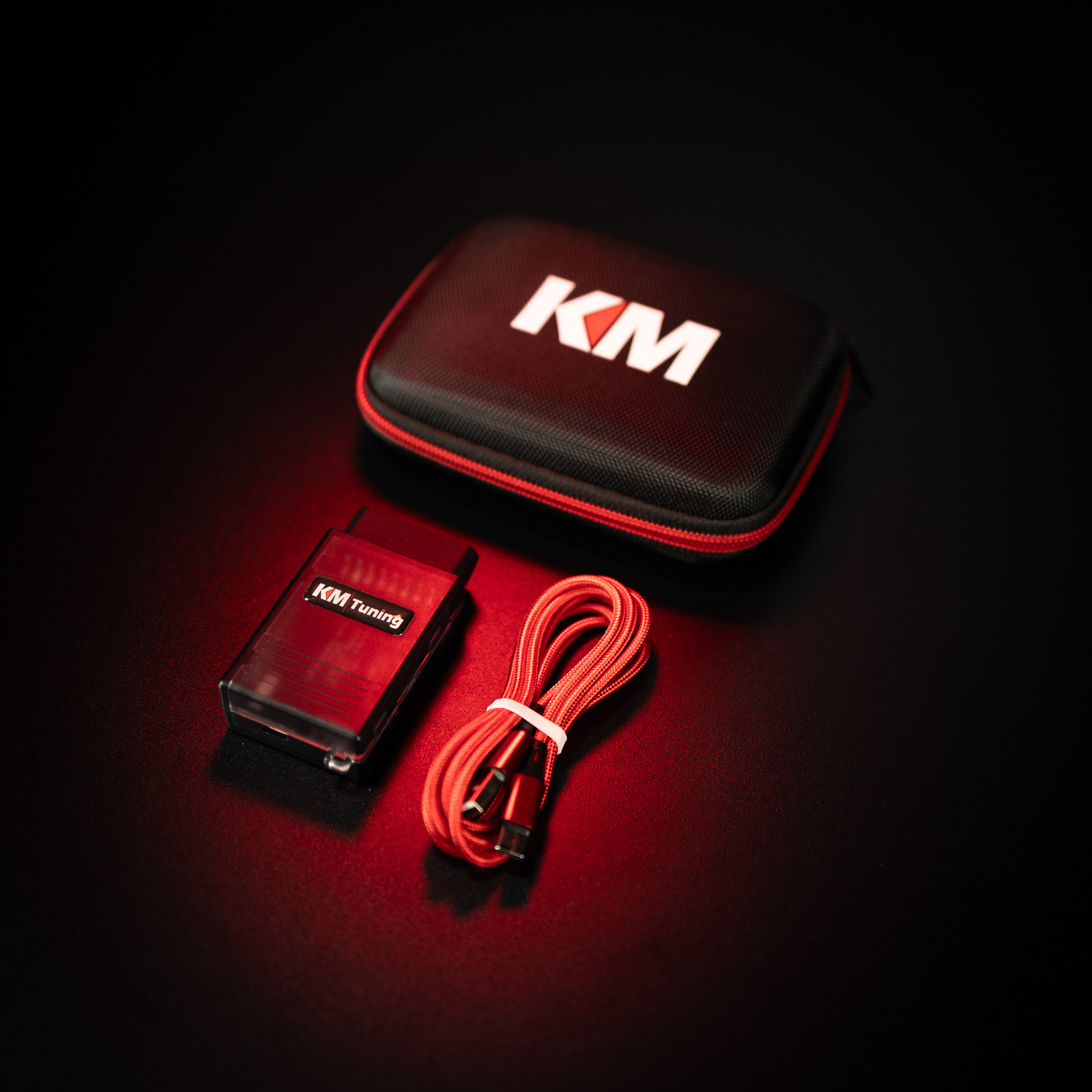 Product image shot of a OBD2 tuning dongle, manufactured by KM Tuning